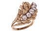 A Modernist diamond-set cocktail ring in the form of a textured foliate, the stylised and layered foliate mount claw-set with five old-cut diamonds, with an estimated total weight of 1.18ct, in unmarked yellow metal surface testing as 14ct, ring head 2.7 