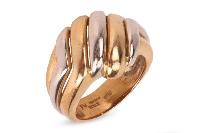 A two-tone dress ring in 18ct gold, of diagonally fluted design, bearing British import marks, size N, 8.8 grams.