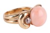 An angelskin coral and diamond dress ring, centred with a button-shaped corallium secundum of 12.6 mm, between bow shoulders adorned with two old-cut diamonds in millgrained collets, with an estimated total weight of 0.28ct, yellow metal stamped '18K', si - 3