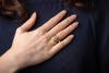 A diamond solitaire ring, of Modernist-style crossover design, composed of a round brilliant diamond measuring approximately 7.25mm with an estimated carat weight of 1.49ct, in a six-prong setting, to a crossover mount, with textured design, hallmarked 18 - 5