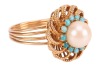 A cultured pearl and turquoise-set dress ring, the cultured pearl surrounded by round turquoise cabochons, with a filigree surround of floral design, to a multi-wire yellow metal shank, with Arabic marks for 18ct, size N; 6.4 grams - 3