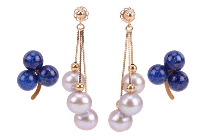 Two pairs of earrings; to include a pair of tassel earrings with cultured pearl drops, on fine serpent links to a beaded surmount with peg and butterfly fittings, in yellow metal stamped '14K', 3.5 cm drop; and another pair of stud earrings of trefoil des