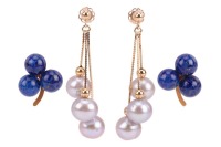 Two pairs of earrings; to include a pair of tassel earrings with cultured pearl drops, on fine serpent links to a beaded surmount with peg and butterfly fittings, in yellow metal stamped '14K', 3.5 cm drop; and another pair of stud earrings of trefoil des
