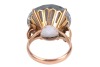 A large synthetic spinel dress ring; set with a round synthetic spinel in pale blue, claw set to a yellow metal mount with floral motif shoulders, to a tapered D-profile shank, marked as '14k', ring head measures 1.9 cm across, ring size M&frac12;, total weight - 4