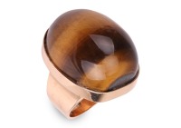 A tiger's eye pinky ring, featuring a large tiger's eye high dome cabochon, measuring 20.7 x 16.6 x 10.3 mm, in a collet to a wide tapering flat shank, yellow metal marked 'K14', size E, 12.8 grams.
