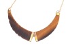 A tiger's eye necklace and a bracelet; the necklace comprising a hinged tiger's eye pendant carved as a twisted horn, with applied stripe decorations, on a fine cable link chain with spring-ring clasp, in yellow metal struck with Italian assay marks for 1 - 3