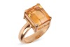 A citrine dress ring, claw-set with a rectangular citrine with canted corners, measures 9.9 x 8.0 x 4.9 mm, to a D-profile shank in yellow metal stamped '18ct' also surface testing as 18ct, size H, 4.8 grams. Please note: Unless otherwise stated, lots hav