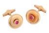 A pair of ruby-set cufflinks, of polished disc form, each centred with an applied round ruby cabochon, toggle fittings to the back, yellow metal stamped '750', signed Serkos and in respective branded case, 1.6 cm wide, 12.5 grams.