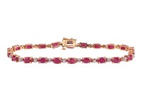 A ruby and diamond line bracelet, comprising a series of oval-cut rubies in articulated claw mounts, flanked by single-cut diamond accents, concealed tongue clasp, yellow metal stamped '14K', overall length 18.0 cm, 7.7 grams.