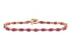 A ruby and diamond line bracelet, comprising a series of oval-cut rubies in articulated claw mounts, flanked by single-cut diamond accents, concealed tongue clasp, yellow metal stamped '14K', overall length 18.0 cm, 7.7 grams.