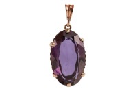 A large synthetic colour change sapphire pendant, claw-set to a reeded mount, on a tapered bail, unmarked metal surface testing as 9ct, 3.7 cm drop, 9.6 grams. Please note: Unless otherwise stated, lots have been tested using an electronic tester. This is