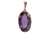 A large synthetic colour change sapphire pendant, claw-set to a reeded mount, on a tapered bail, unmarked metal surface testing as 9ct, 3.7 cm drop, 9.6 grams. Please note: Unless otherwise stated, lots have been tested using an electronic tester. This is