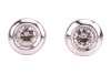 A pair of diamond-set stud earrings, composed of round brilliant diamonds, with an estimated total carat weight of 0.34ct, bezel-set in 18ct white gold mounts, the unassociated white metal earring backs marked &lsquo;9K&rsquo; and the other &lsquo;925&rsquo;; 2.1 grams