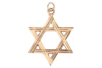 A Star of David pendant, with engraved striations, on a suspension loop, hallmark partially rubbed, yellow metal surface testing as 14ct, 2.7 cm wide, 7.1 grams. Please note: Unless otherwise stated, lots have been tested using an electronic tester. This 