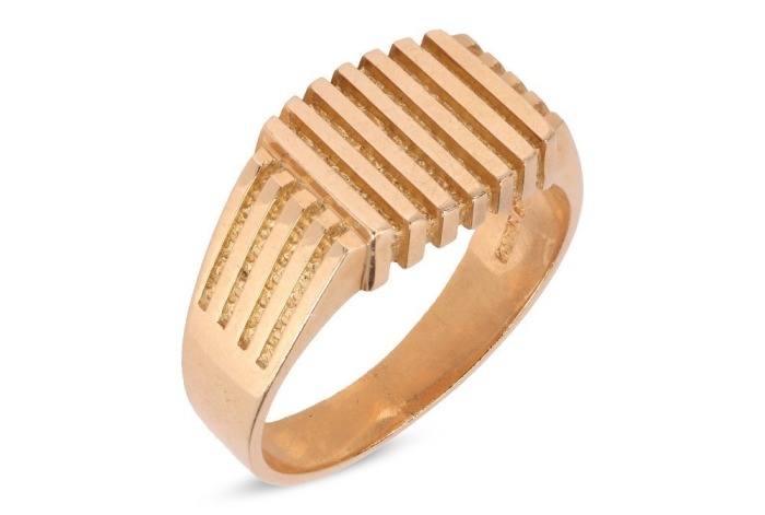 A signet ring with parallel ridged decoration, to a tapering flat shank stamped '18ct', size Z, 15.53 grams.
