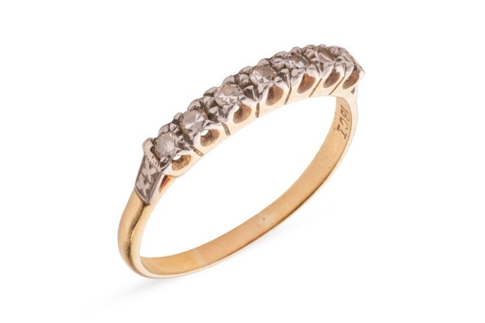 A diamond-set half hoop ring, claw-set with seven single-cut diamonds, to a bi-colour metal mount marked &lsquo;18ct&rsquo; and &lsquo;Plat&rsquo;, size Q; 2.3 grams