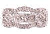An Art Deco style diamond-set ring, centrally set with a row of four princess-cut diamonds, flanked by an additional two bezel-set princess-cut diamonds, between two scalloped rows of round brilliant-cut diamonds, to a white metal mount marked &lsquo;18K&rsquo; and &lsquo; - 2