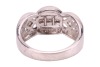 An Art Deco style diamond-set ring, centrally set with a row of four princess-cut diamonds, flanked by an additional two bezel-set princess-cut diamonds, between two scalloped rows of round brilliant-cut diamonds, to a white metal mount marked &lsquo;18K&rsquo; and &lsquo; - 4