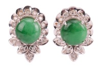 A pair of jadeite and diamond-set cluster earrings, of foliate design, centrally-set with a round jadeite cabochon, surrounded by round brilliant diamonds, in an unmarked white metal mount, surface tested as 18ct, with post fittings to the reverse and but