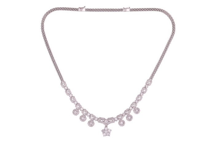 A diamond-set fringe-style necklace, composed of diamond-set openwork links with millegrain detailing, connected with round brilliant diamonds measuring between 3.2mm to 4mm each, suspending six diamond-set floral cluster drops and a larger removable diam