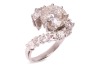 A diamond-set crossover-style ring, featuring a central round brilliant diamond, measuring approximately 9.1mm x 5.2mm, with an estimated carat weight of 3.00ct and an estimated colour and clarity grade of J/K and I2, the crossover-style shoulders each cl - 2