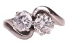 A diamond-set toi et moi ring, composed of two round brilliant diamonds, measuring approximately 5.8mm, with an estimated total carat weight of 1.50ct, claw-set in a crossover design, in an 18ct white gold mount, size N1/2; 5.0 grams - 2