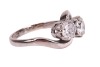 A diamond-set toi et moi ring, composed of two round brilliant diamonds, measuring approximately 5.8mm, with an estimated total carat weight of 1.50ct, claw-set in a crossover design, in an 18ct white gold mount, size N1/2; 5.0 grams - 4