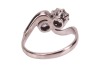 A diamond-set toi et moi ring, composed of two round brilliant diamonds, measuring approximately 5.8mm, with an estimated total carat weight of 1.50ct, claw-set in a crossover design, in an 18ct white gold mount, size N1/2; 5.0 grams - 5