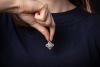 A diamond-set pendant, of rounded lozenge outline, featuring a central panel of princess-cut diamonds, in an invisible setting, within a pav&eacute;-set diamond surround, to a diamond-set bail, in white metal marked &lsquo;750&rsquo;, measuring approximately 39mm including - 3