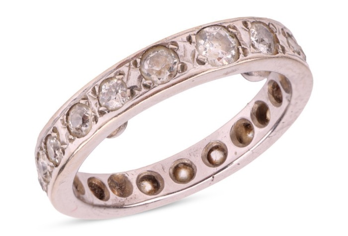 A diamond-set full eternity ring, grain-set with old-cut diamonds, of various sizes, in an unmarked white metal mount, surface tested as 18ct, size K (measured with beads); 4.7 grams Please note: Unless otherwise stated, lots have been tested using an ele