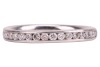 A diamond-set half-eternity ring, featuring a channel of nineteen round brilliant-cut diamonds, set in platinum, size J, 3.5 grams. - 2