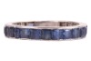 A sapphire eternity ring, featuring twenty-two square and calibre-cut blue sapphires channel-set in white metal surface testing as platinum (insert to back of ring surface testing as base metal), size P, 3.03 grams. Please note: Unless otherwise stated, l - 2