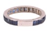A sapphire eternity ring, featuring twenty-two square and calibre-cut blue sapphires channel-set in white metal surface testing as platinum (insert to back of ring surface testing as base metal), size P, 3.03 grams. Please note: Unless otherwise stated, l - 3