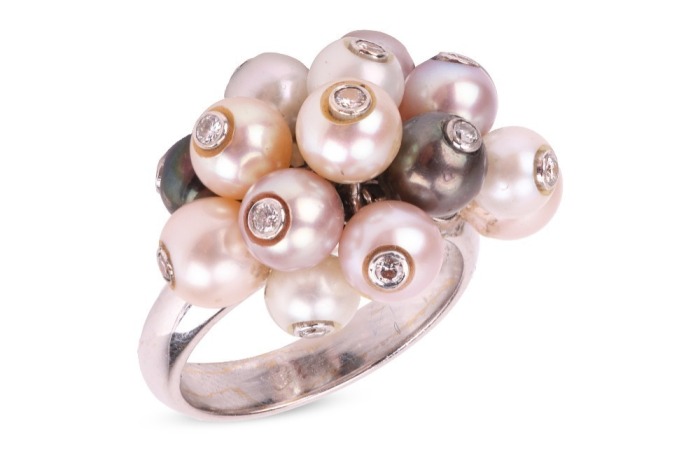 A pearl and diamond-set cluster ring, composed of cultured pearls of various body colours, each bezel-set with a round brilliant diamond, with attached jump rings connected to a court-shaped 18ct white gold shank, size L; 9.0 grams