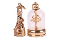 Two 9ct gold pendant charms, including a lighthouse, the interior with a cultured pearl and signed by Litacharm, the second pendant depicting a ballerina in a glass cloche, hallmarked Birmingham 1964; 22.0 grams (2)