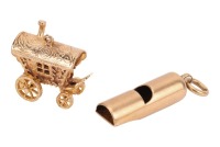 Two charms; to inclulde a whistle on a suspension loop, in yellow metal stamped '18', 5.0 grams; and a caravan with spinning wheels, testing as gilt metal. (2) Please note: Unless otherwise stated, lots have been tested using an electronic tester. This is
