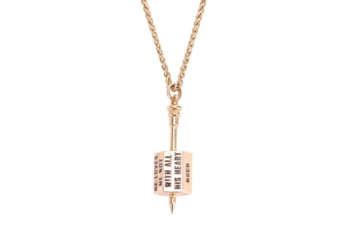 A spinner pendant on chain, featuring a stylised spinning top pendant engraved with levels of affection such as 'with all his heart' and 'he loves me not', surface testing as 18ct, the pendant to a yellow metal rope link chain surface testing as 9ct, meas