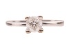 A diamond solitaire ring, consisting of a round brilliant-cut diamond with an estimated weight of 0.35ct, mounted in a high-profile claw setting, between tapered shoulders, in unmarked white metal surface testing as 14ct, size J, 3.0 grams. Please note: U - 2