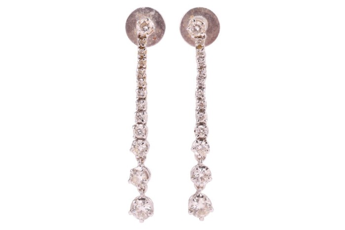 A pair of diamond-set drop earrings, of tapering design, each claw-set with thirteen graduated round brilliant diamonds, in 18ct white gold mounts, with post fittings and earring backs to the reverse; 2.6 grams