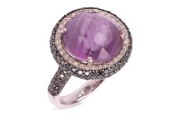 An amethyst and diamond dress ring, featuring a central claw-set round mixed-cut amethyst of vivid purple colour, measuring 13.4mm in diameter, encircled by a curved border grain-set with a single row of round brilliant-cut diamonds and an additional thre