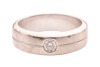 A diamond-set dress ring, flush-set with a round brilliant-cut diamond with an estimated weight of 0.20ct, to a band with a central indentation, Indian assay marks '750', size P, 10.0 grams. - 2