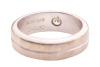 A diamond-set dress ring, flush-set with a round brilliant-cut diamond with an estimated weight of 0.20ct, to a band with a central indentation, Indian assay marks '750', size P, 10.0 grams. - 4