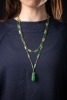 A long jadeite link chain, comprising a series of Figaro links, flanked by faceted jadeite bar links with a chamfered edge, suspending a carved jadeite Fuu dog seal with vacant panel, yellow metal surface testing as 14ct, with a gilt suspension loop bail, - 4