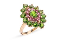 A chrome diopside and garnet cluster ring in 9ct yellow gold, the navette-shaped cluster centred with an oval-cut chrome diopside, framed by a frame of circular-cut garnets and an outer frame of circular-cut diopsides, between tapered shoulders, British h