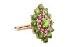 A chrome diopside and garnet cluster ring in 9ct yellow gold, the navette-shaped cluster centred with an oval-cut chrome diopside, framed by a frame of circular-cut garnets and an outer frame of circular-cut diopsides, between tapered shoulders, British h - 4
