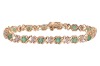 An emerald line bracelet, comprising fourteen round-cut emeralds, interspersed by stylised cross forms and a white-metal illusion panel, every other white metal panel illusion-set with a rose-cut diamond, measuring 18.0cm in length, completed with an inte