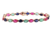 A multi-gem set bracelet, composed of oval mixed-cut glass-filled rubies, dyed sapphires and emeralds, claw-set in an alternating pattern, in a yellow metal mount with integrated push bar clasp and safety catch, marked &rsquo;18K&rsquo;, measuring approximately 19.5c