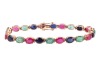 A multi-gem set bracelet, composed of oval mixed-cut glass-filled rubies, dyed sapphires and emeralds, claw-set in an alternating pattern, in a yellow metal mount with integrated push bar clasp and safety catch, marked &rsquo;18K&rsquo;, measuring approximately 19.5c