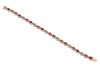 A multi-gem set bracelet, composed of oval mixed-cut glass-filled rubies, dyed sapphires and emeralds, claw-set in an alternating pattern, in a yellow metal mount with integrated push bar clasp and safety catch, marked &rsquo;18K&rsquo;, measuring approximately 19.5c - 2