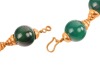 An agate bead necklace, comprising fourteen spherical dyed agate beads of 16.5mm, capped with graduated cups, completed with a hook clasp with twisted cable details, unmarked yellow metal surface testing as 18ct, overall length 43.0 cm, 99.6 grams. Please - 2
